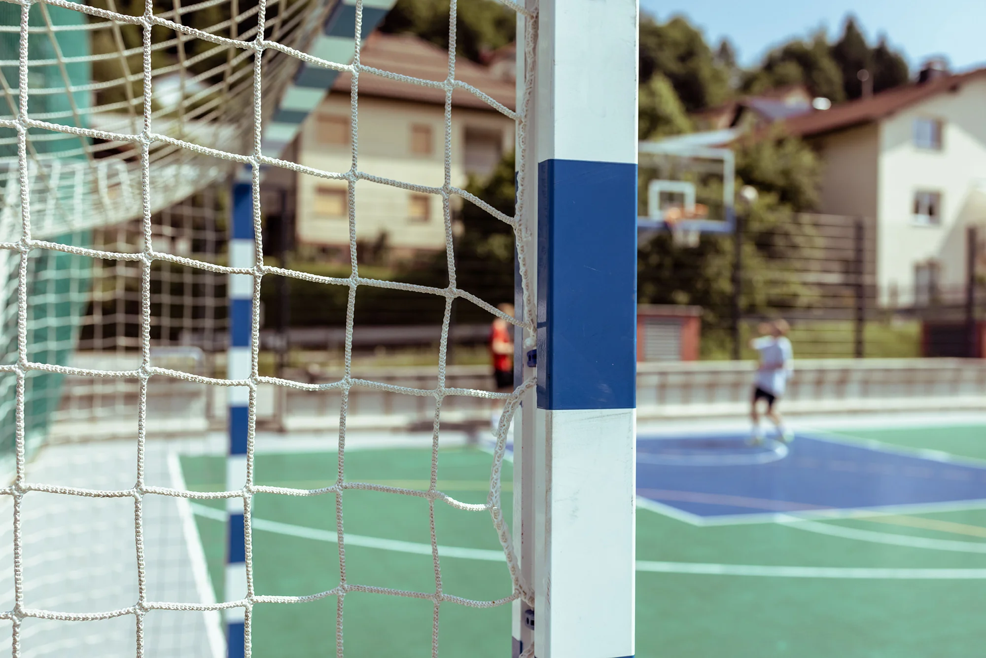 close up view of a soccer goal with a blurred back