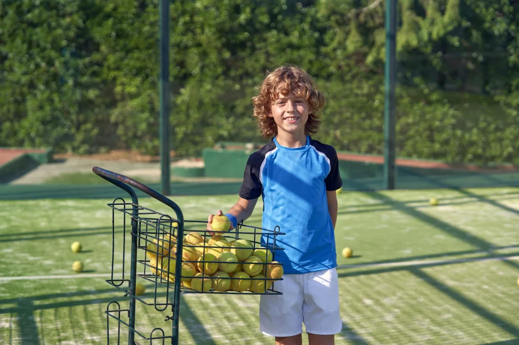 content boy with balls on court