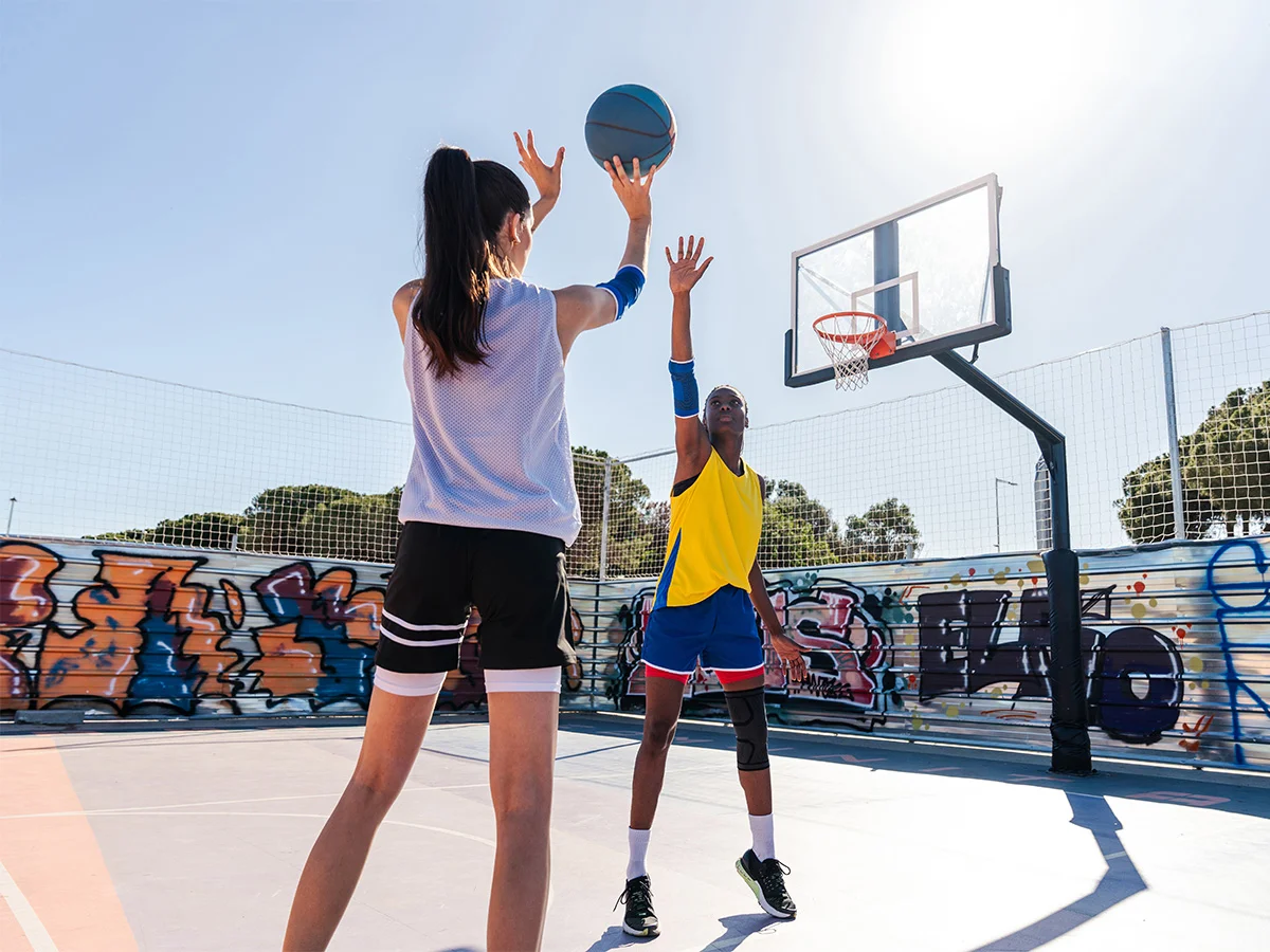 female basketball players training at city basketb