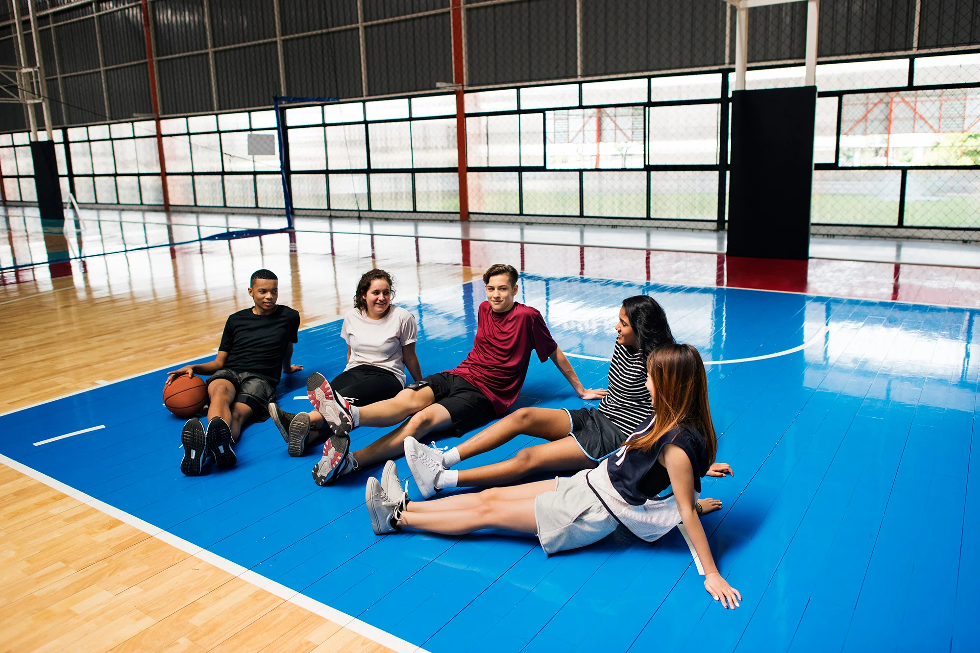 group of young teenager friends on a basketball