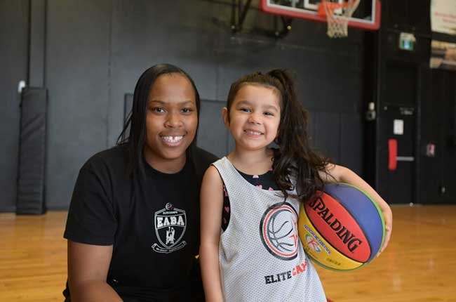 kid and coach at basketball camp