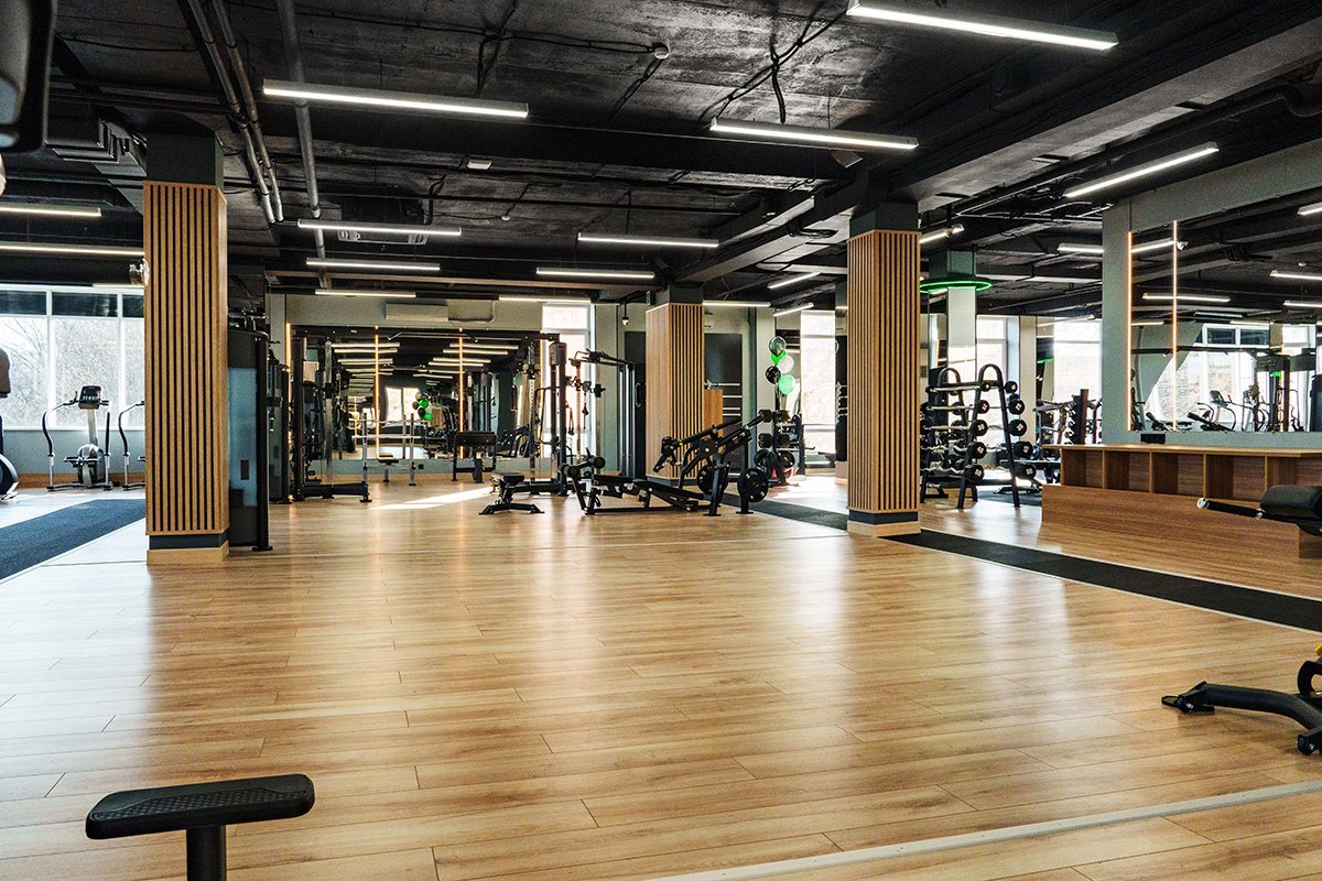 modern gym interior with wooden flooring and vario