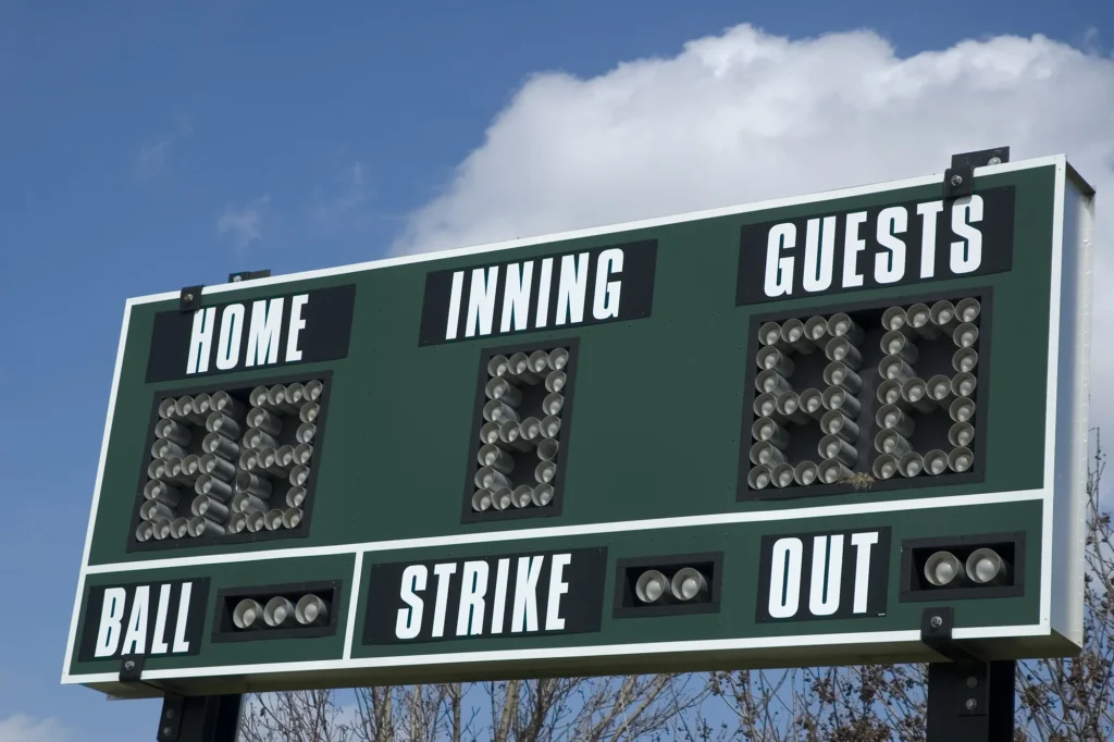 scoreboard above softball field on a spring
