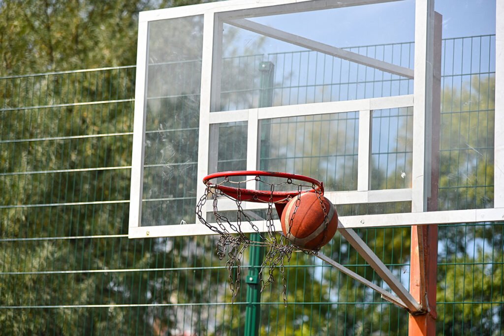 shooting orange basketball ball into the basket