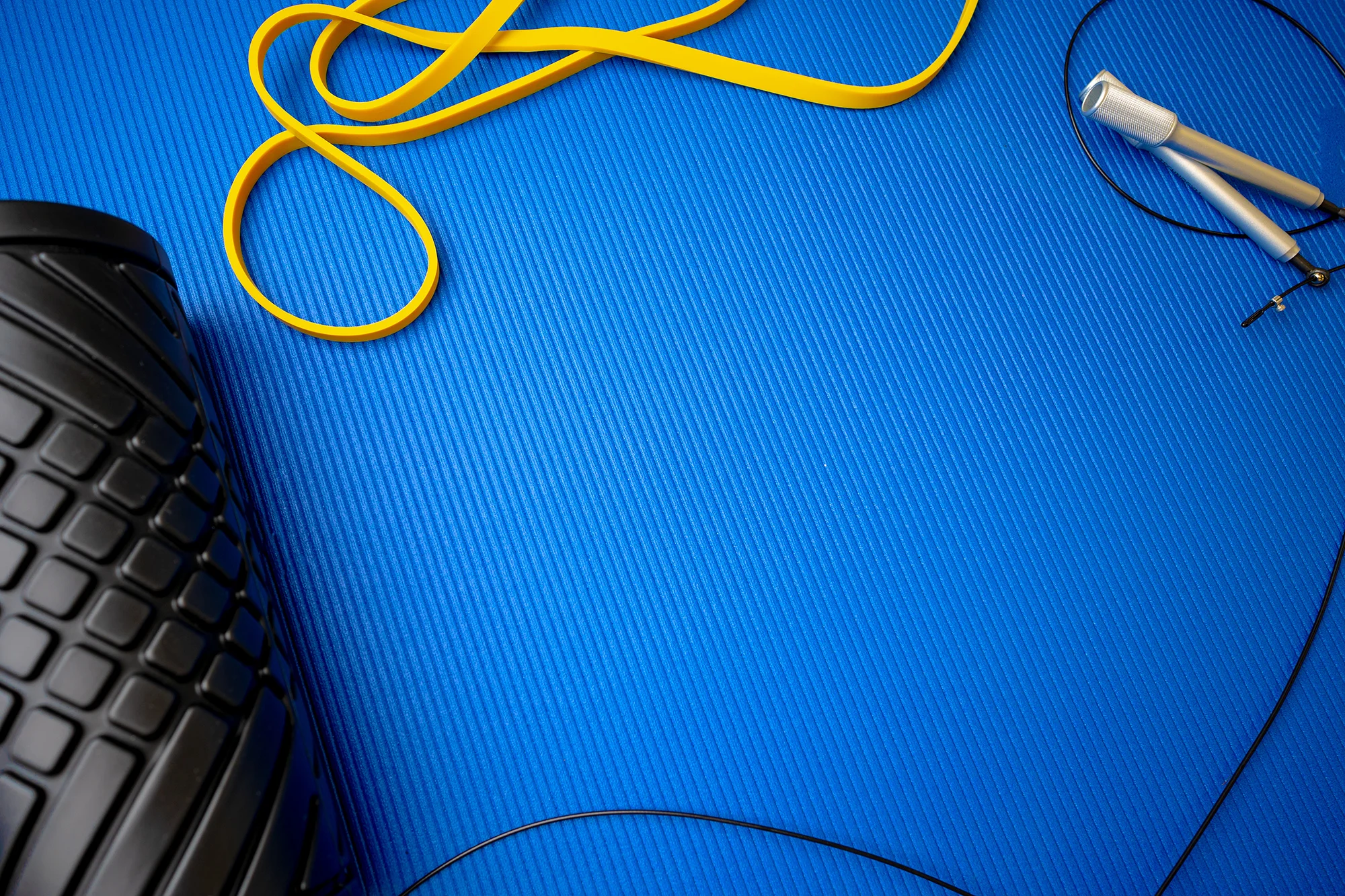 sport fitness foam roller on blue mat