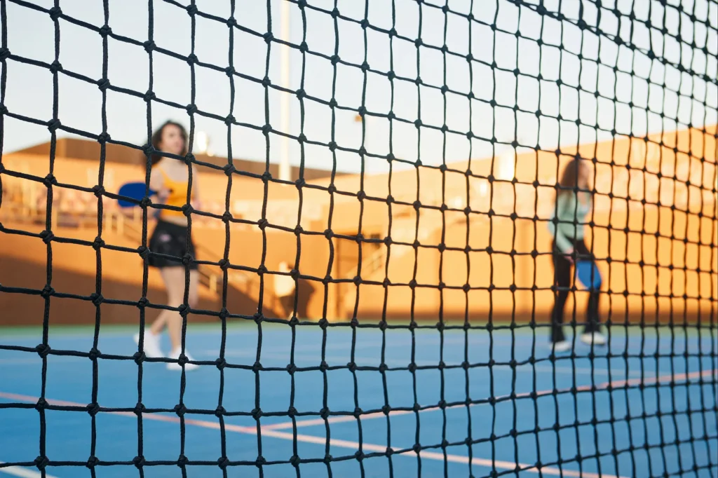 young adults learning and playing pickleball