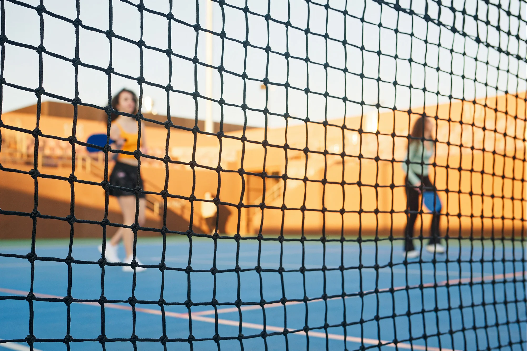 young adults learning and playing pickleball